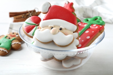 Photo of Decorated Christmas cookies on white wooden table, closeup