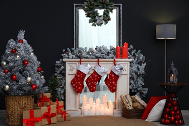 Fireplace with Christmas stockings in festive room interior