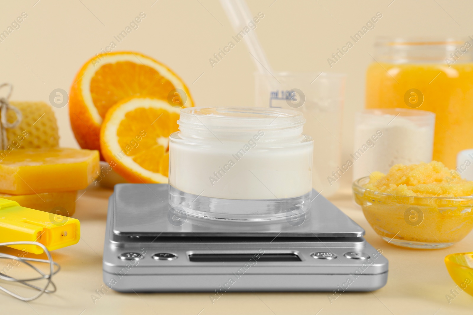 Photo of Homemade cosmetic products and fresh ingredients on beige background, closeup