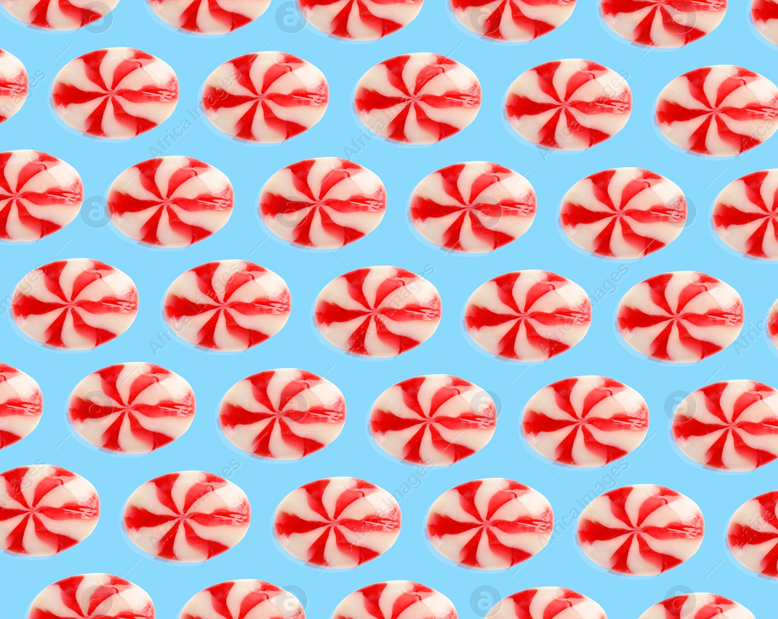 Image of Tasty candies on light blue background. Pattern design
