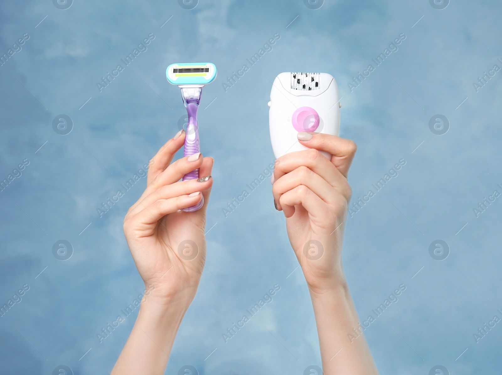 Photo of Woman holding modern epilator and razor on color background, closeup