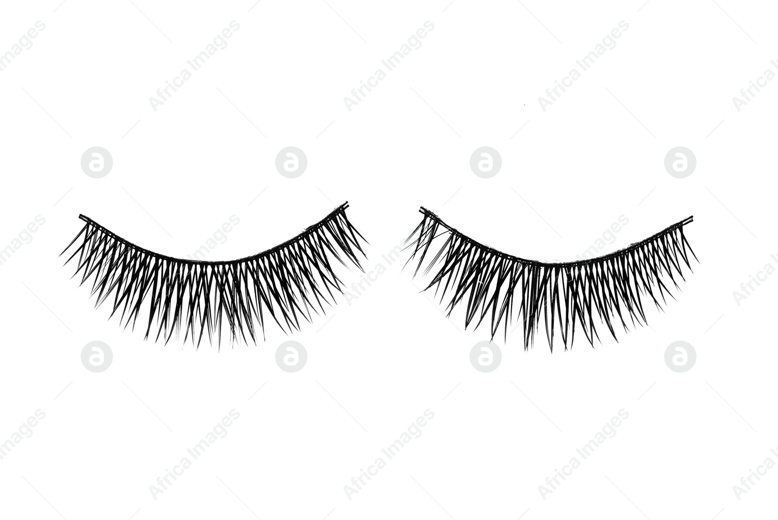 Photo of Fake eyelashes on white background, top view. Makeup product