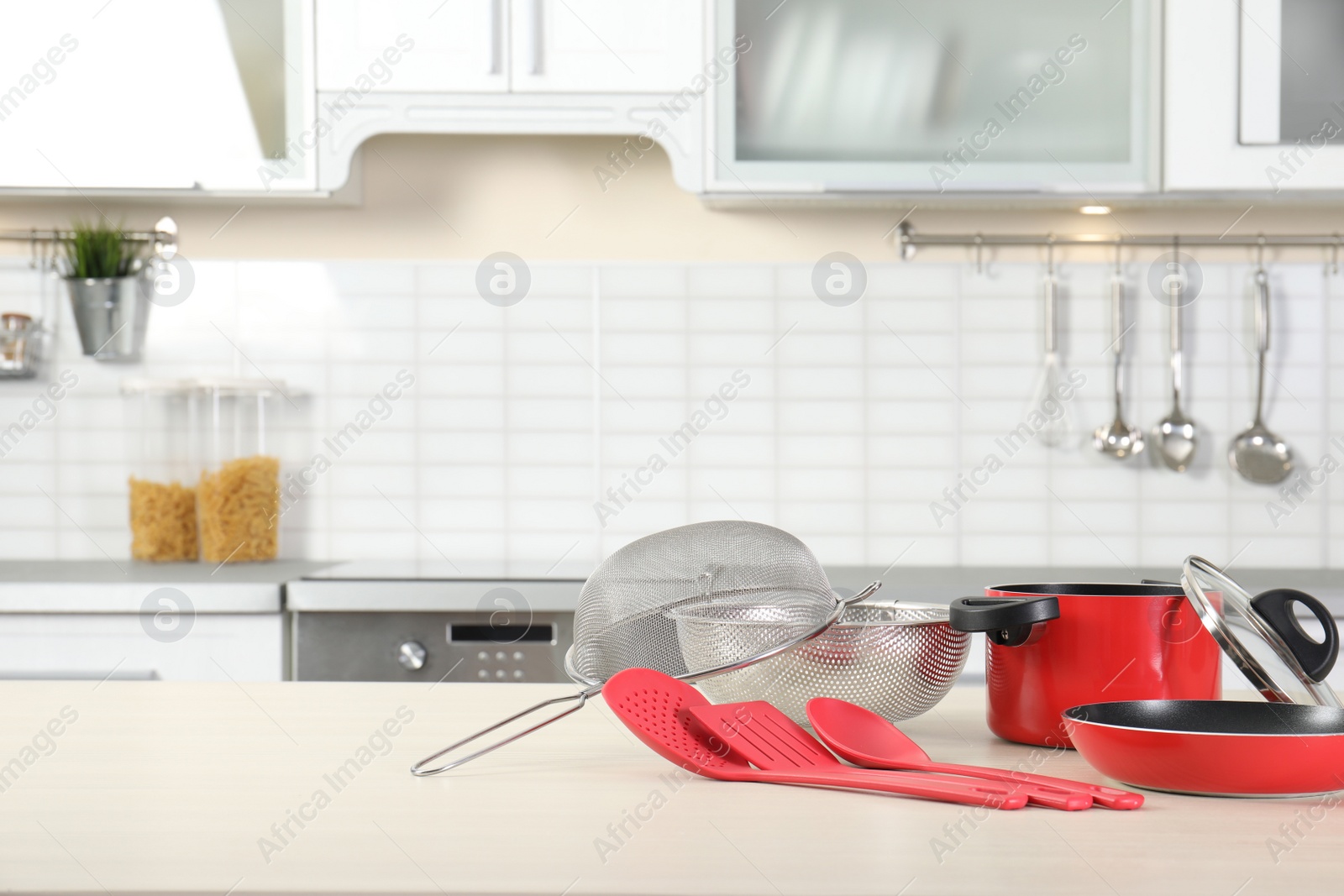 Photo of Set of clean cookware and utensils on table in kitchen. Space for text