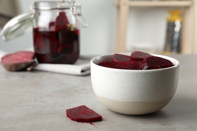 Photo of Pickled beets in bowl on light table, space for text
