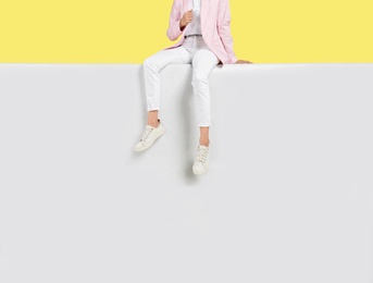 Photo of Woman wearing stylish shoes on color background, closeup