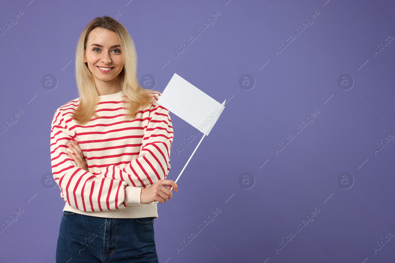 Photo of Happy woman with blank white flag on violet background. Mockup for design