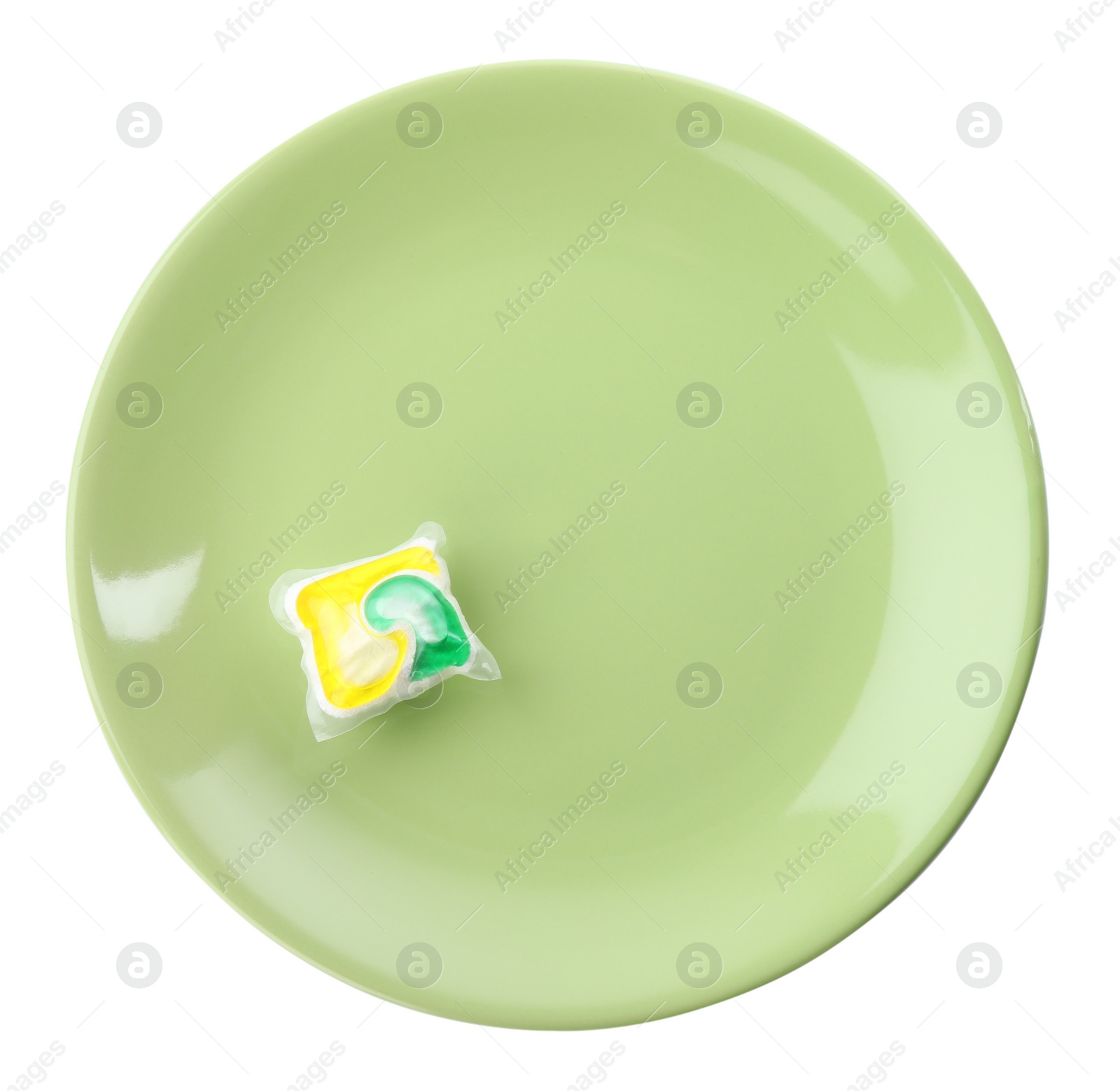 Photo of Green plate with dishwasher detergent pod on white background, top view