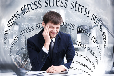 Image of Young man suffering from depression and words STRESS in office