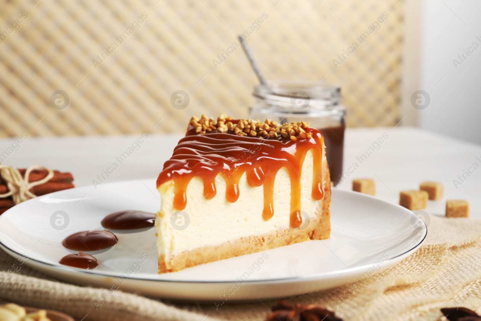 Photo of Tasty cheesecake with caramel and nuts served on table