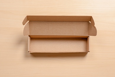 Photo of Cardboard box on wooden background