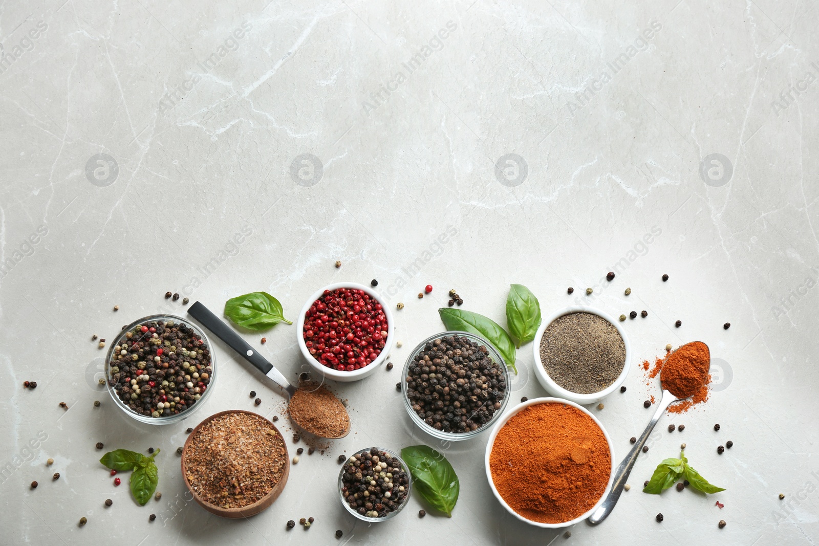 Photo of Flat lay composition with ground pepper and corns on marble table. Space for text