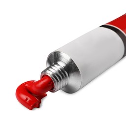 Photo of Tube with red oil paint on white background