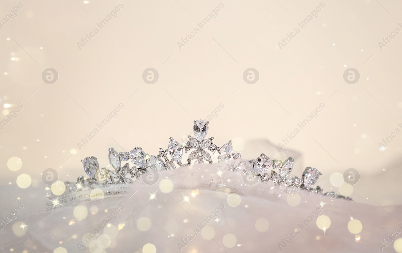 Image of Beautiful tiara with diamonds on cloth, space for text. Bokeh effect