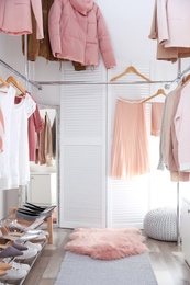 Photo of Modern dressing room with different stylish clothes and accessories