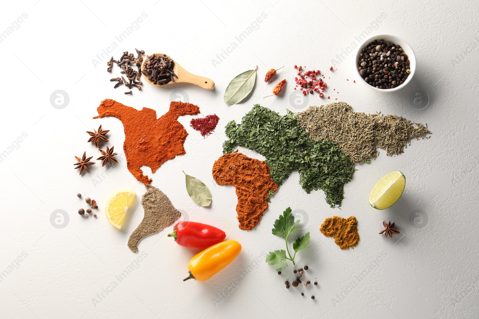 Photo of World map of different spices and products on white textured table, flat lay