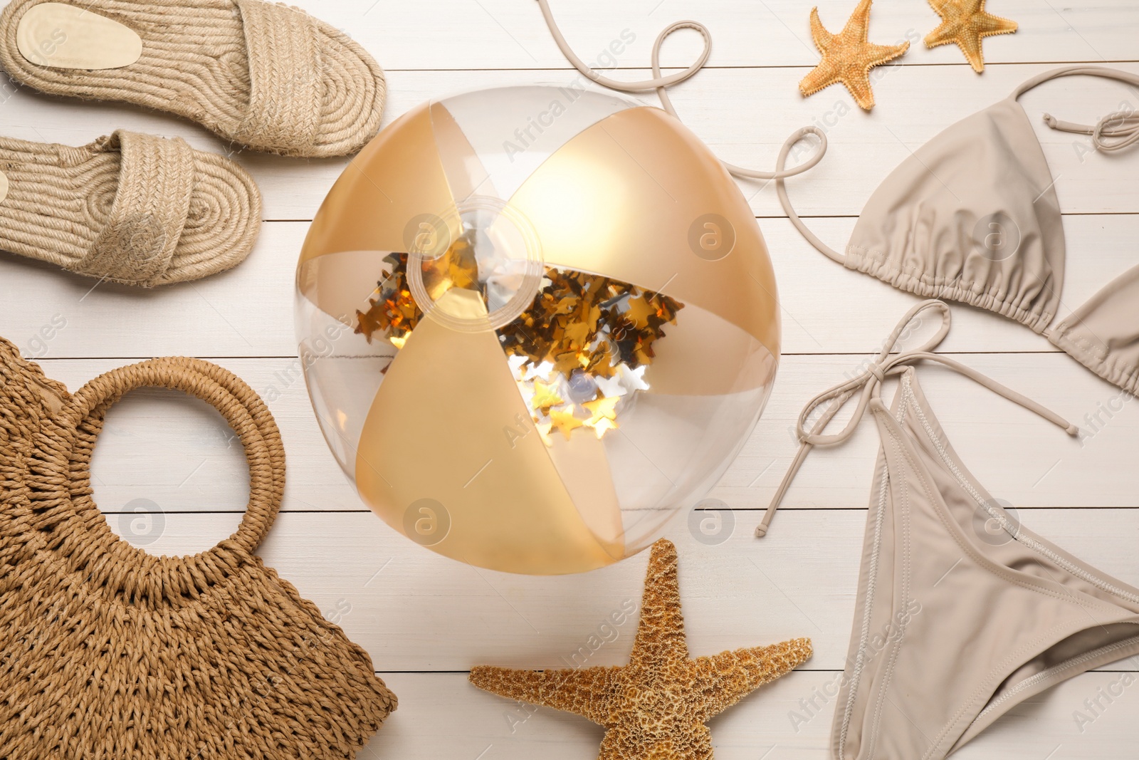 Photo of Flat lay composition with beach ball and other accessories on white wooden background