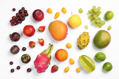 Photo of Many different delicious exotic fruits on white background, flat lay