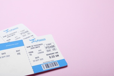 Photo of Tickets on pink background, space for text. Travel agency concept