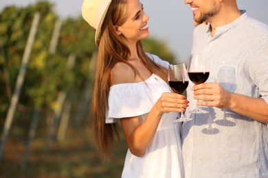 Photo of Happy couple holding glasses of wine outdoors, closeup view