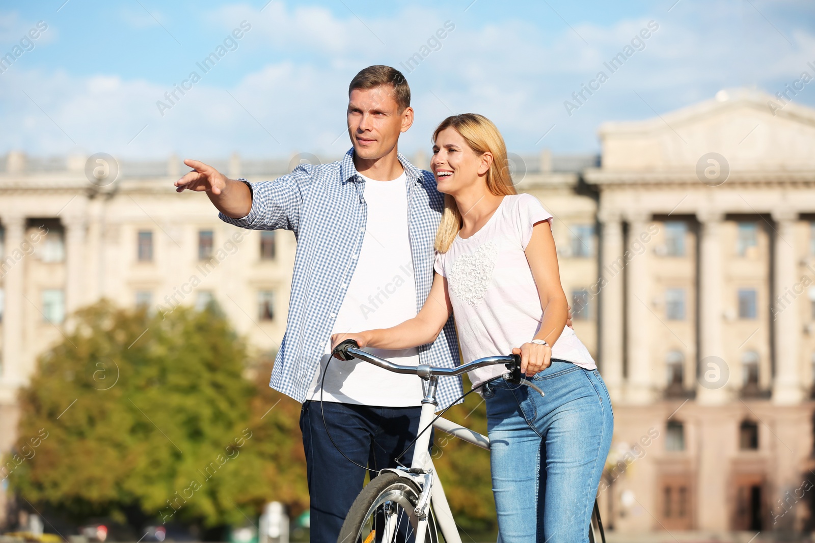 Photo of Happy couple with bicycle outdoors on sunny day