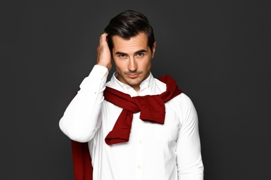 Portrait of handsome young man on dark background