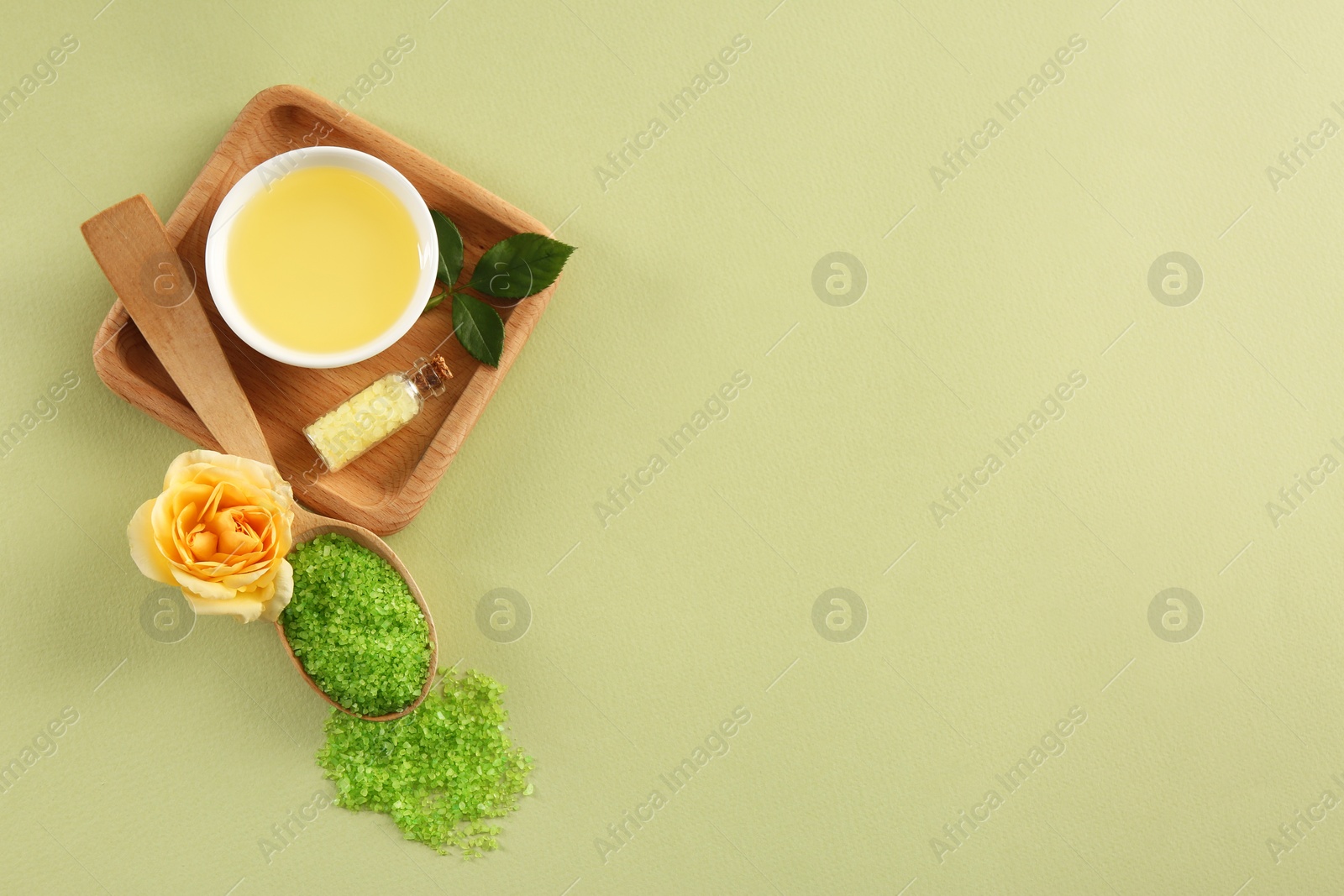 Photo of Flat lay composition with aromatic sea salt and beautiful flower on pale green background. Space for text