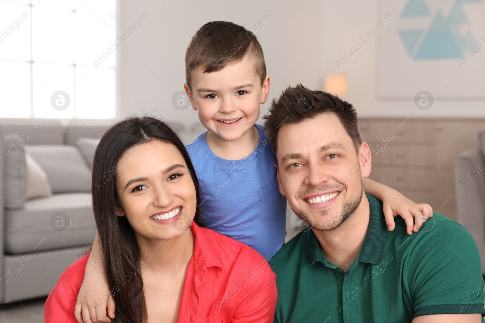 Photo of Happy parents and their son at home. Family portrait