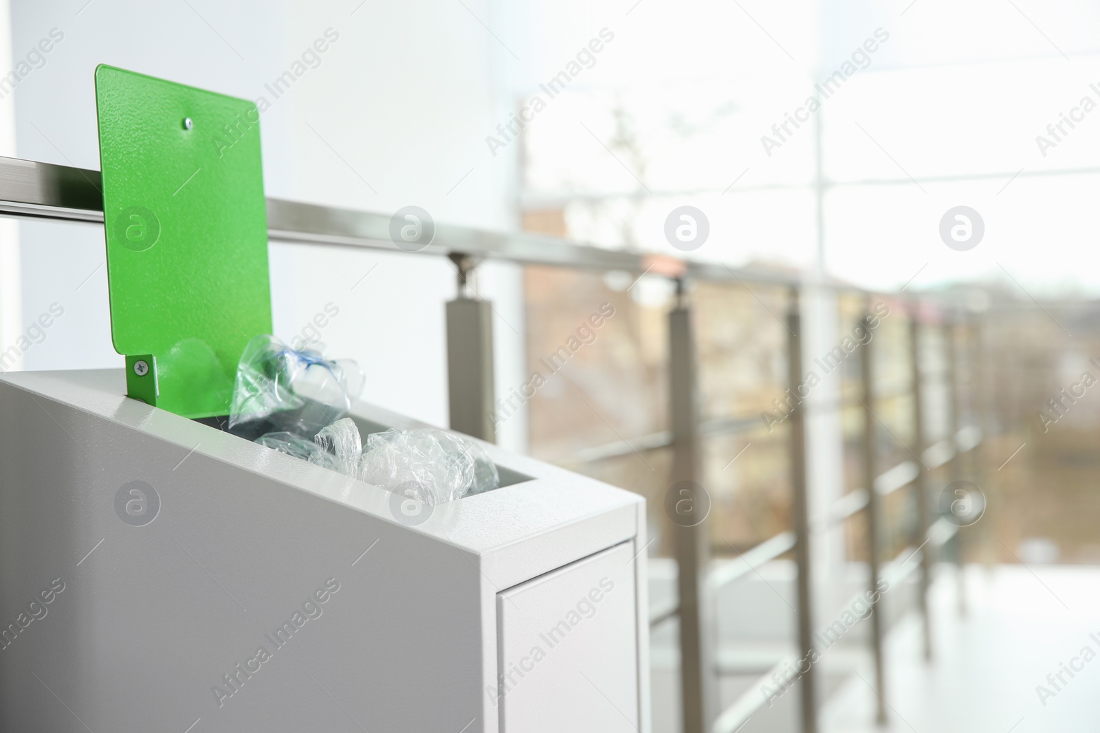 Photo of Metal bin with garbage indoors, space for text. Waste recycling