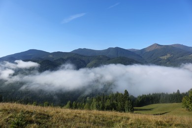 Picturesque view of mountains covered with fog