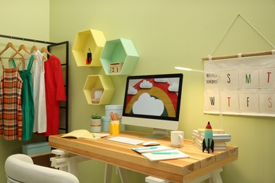 Stylish workplace with computer on wooden desk indoors. Interior design