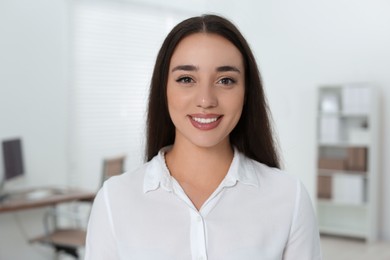 Photo of Portrait of beautiful young woman in office