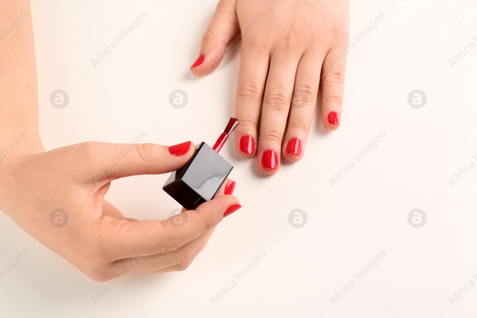 Photo of Woman applying nail polish on white background, closeup