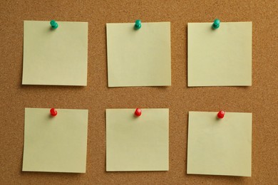 Photo of Beige paper notes pinned to cork board