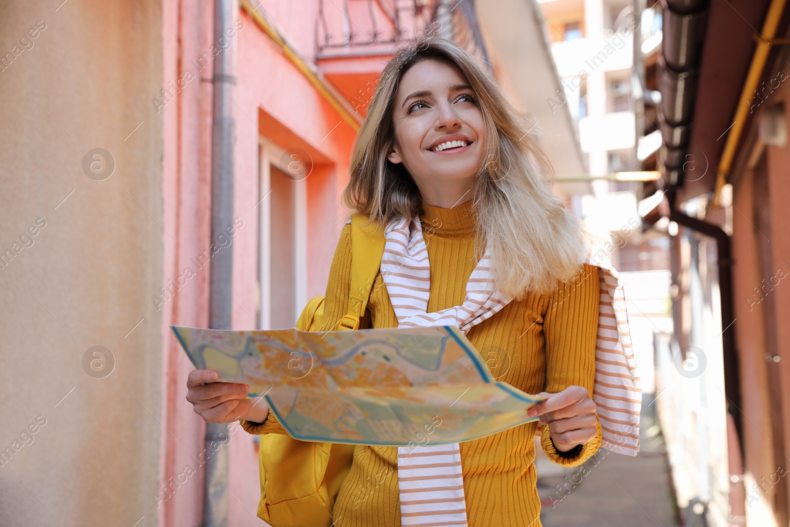 Photo of Tourist with map walking on city street