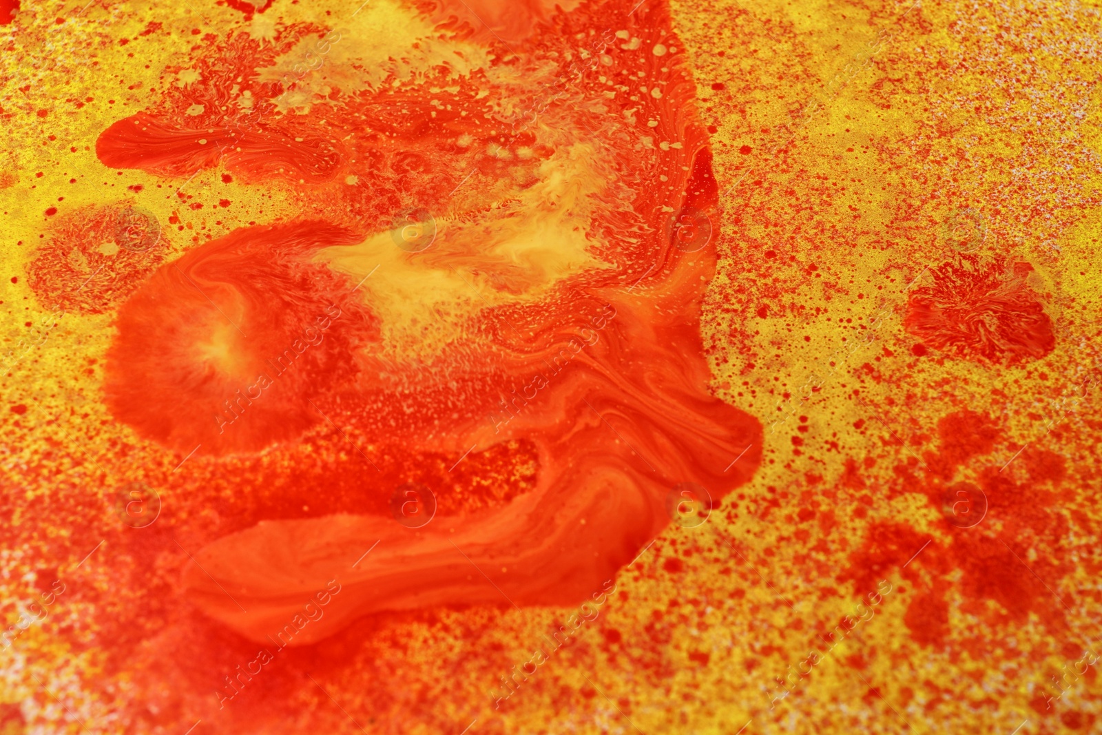 Photo of Texture of orange paint with colorful splotches as background, closeup