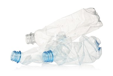 Photo of Crumpled disposable plastic bottles isolated on white