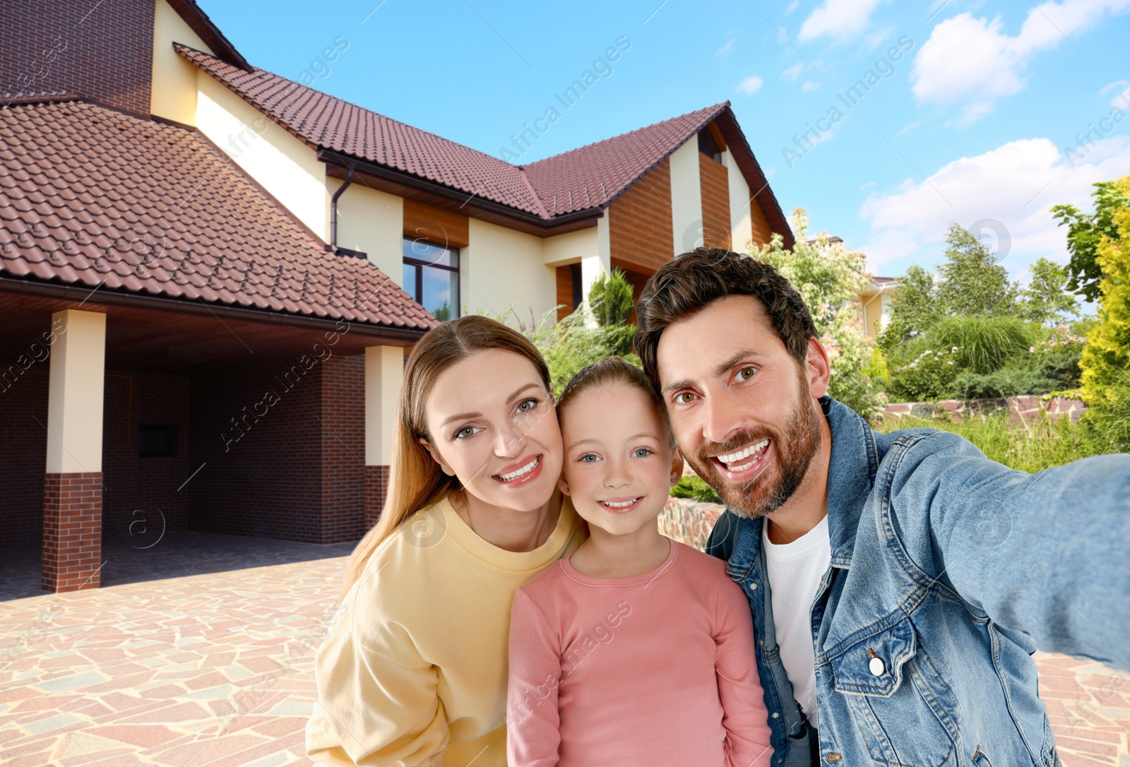 Image of Happy family with child taking selfie near house