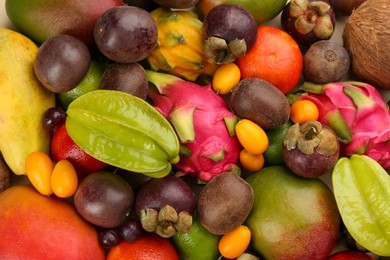 Assortment of fresh exotic fruits as background, top view