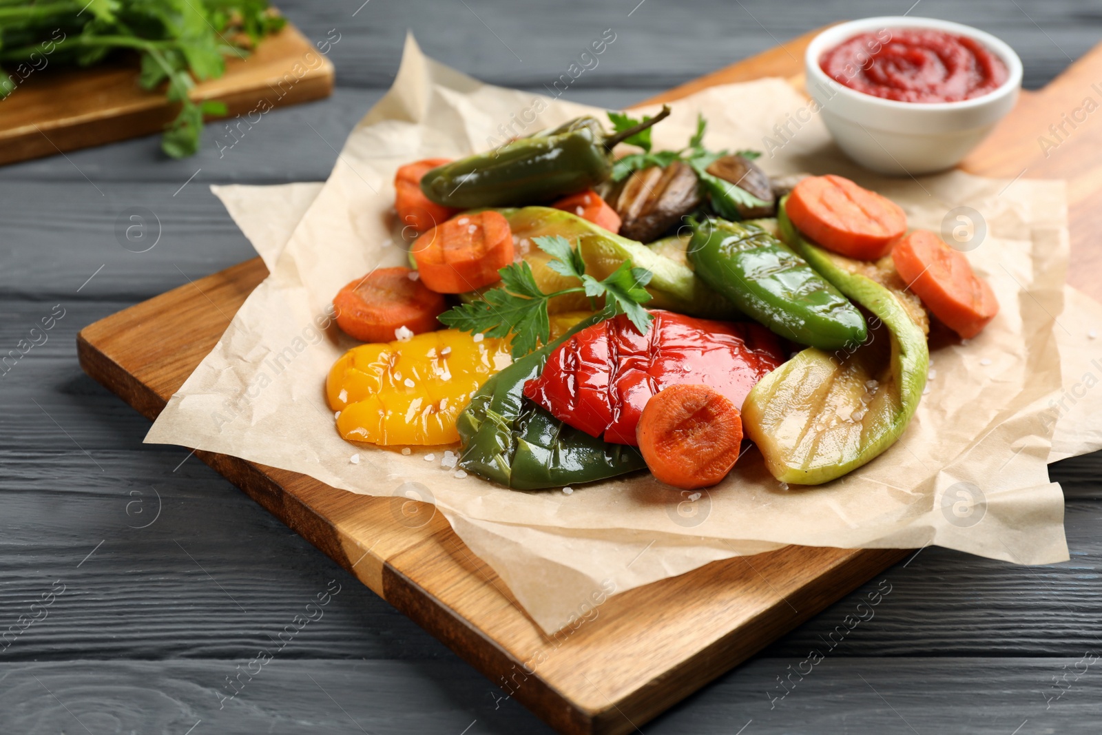 Photo of Delicious grilled vegetables on grey wooden table, closeup