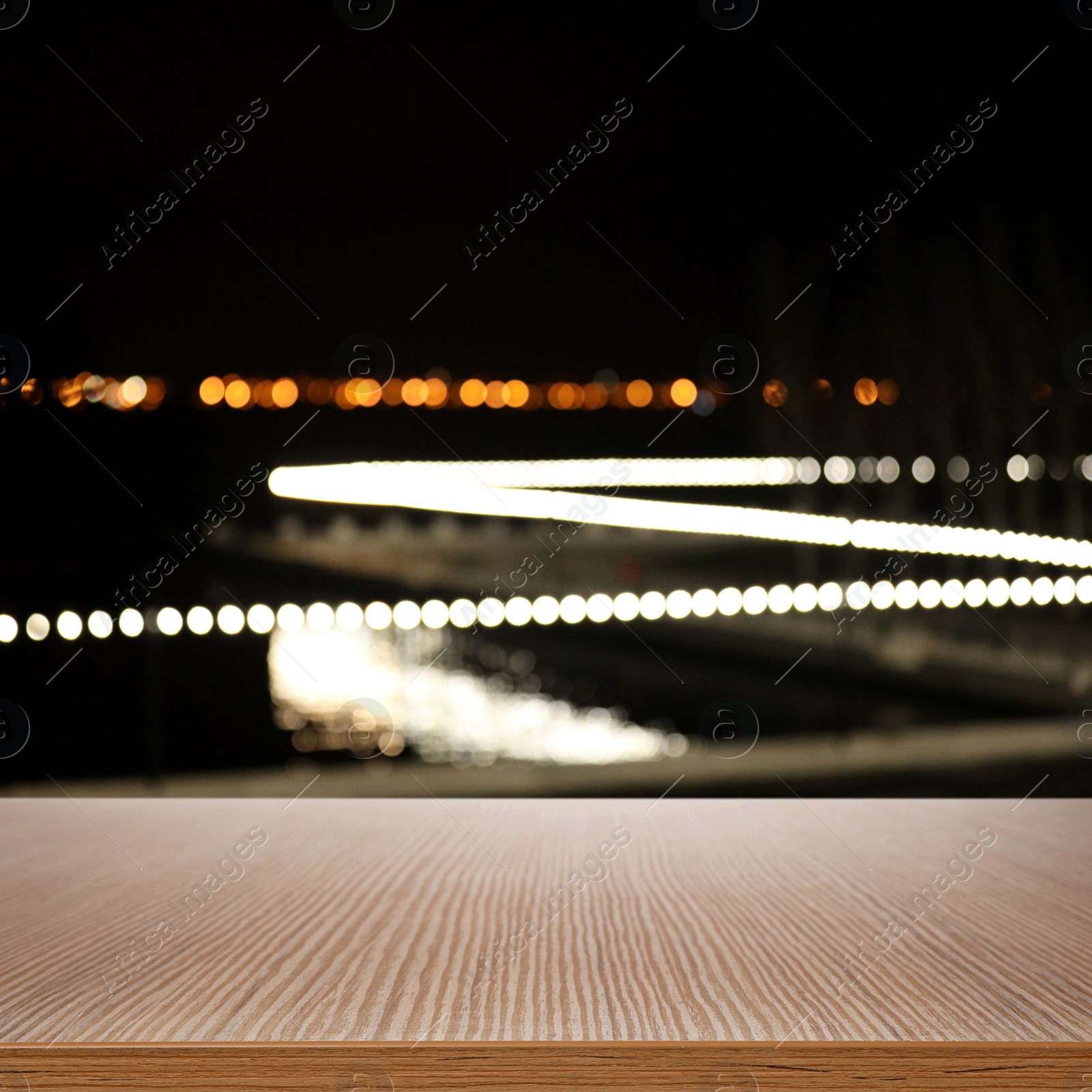 Image of Empty wooden surface and blurred view of night city. Bokeh effect 