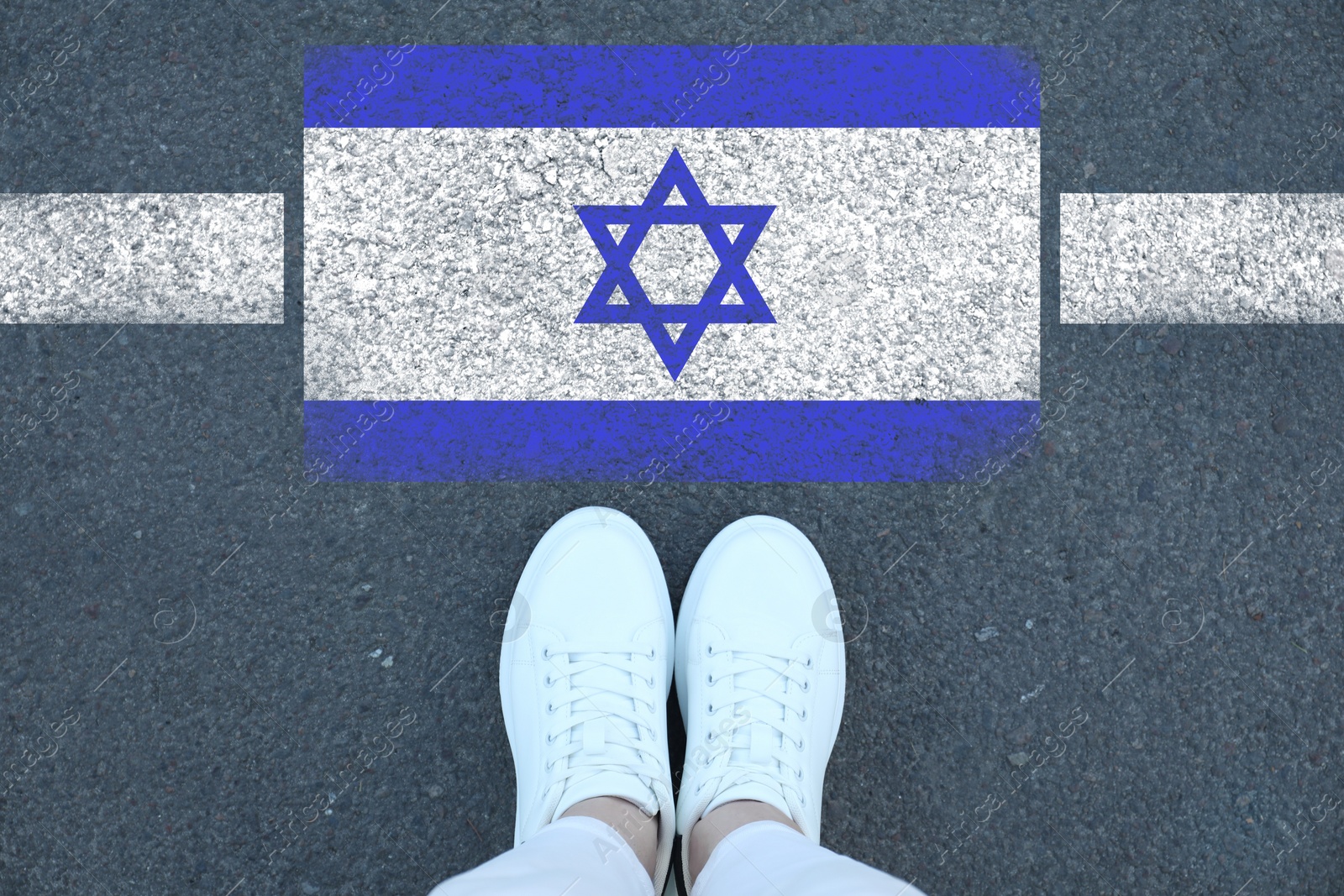 Image of Immigration. Woman standing on asphalt near flag of Israel, top view