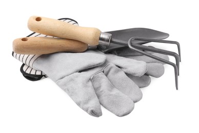 Gardening gloves, trowel and rake isolated on white