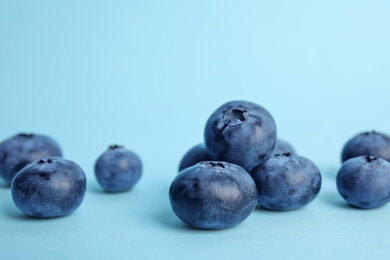 Photo of Tasty ripe blueberry on color background, closeup