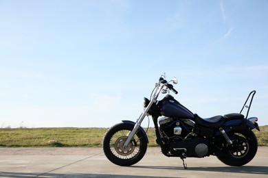 Modern black motorcycle on sunny day outdoors