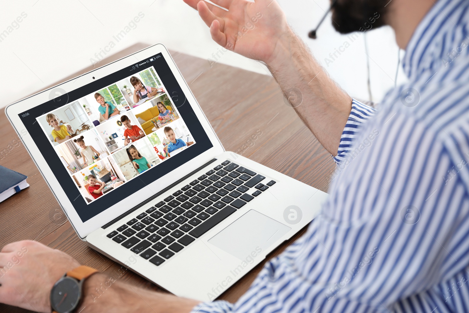 Image of Teacher giving online school lesson during quarantine and social distancing due to Covid-19 pandemic, closeup. Pupils studying at home via video conference