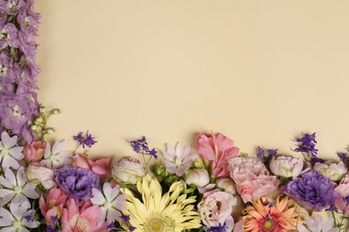 Photo of Flat lay composition with different beautiful flowers on beige background, space for text