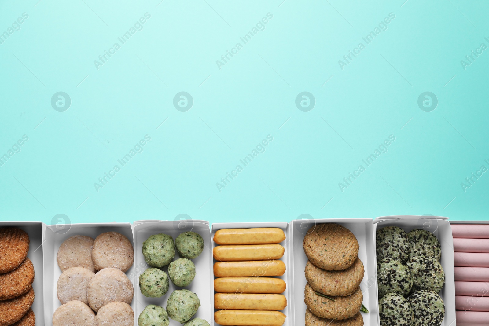 Photo of Many different raw vegan meat products on turquoise background, flat lay. Space for text