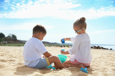 Photo of Little children playing on sea beach outside