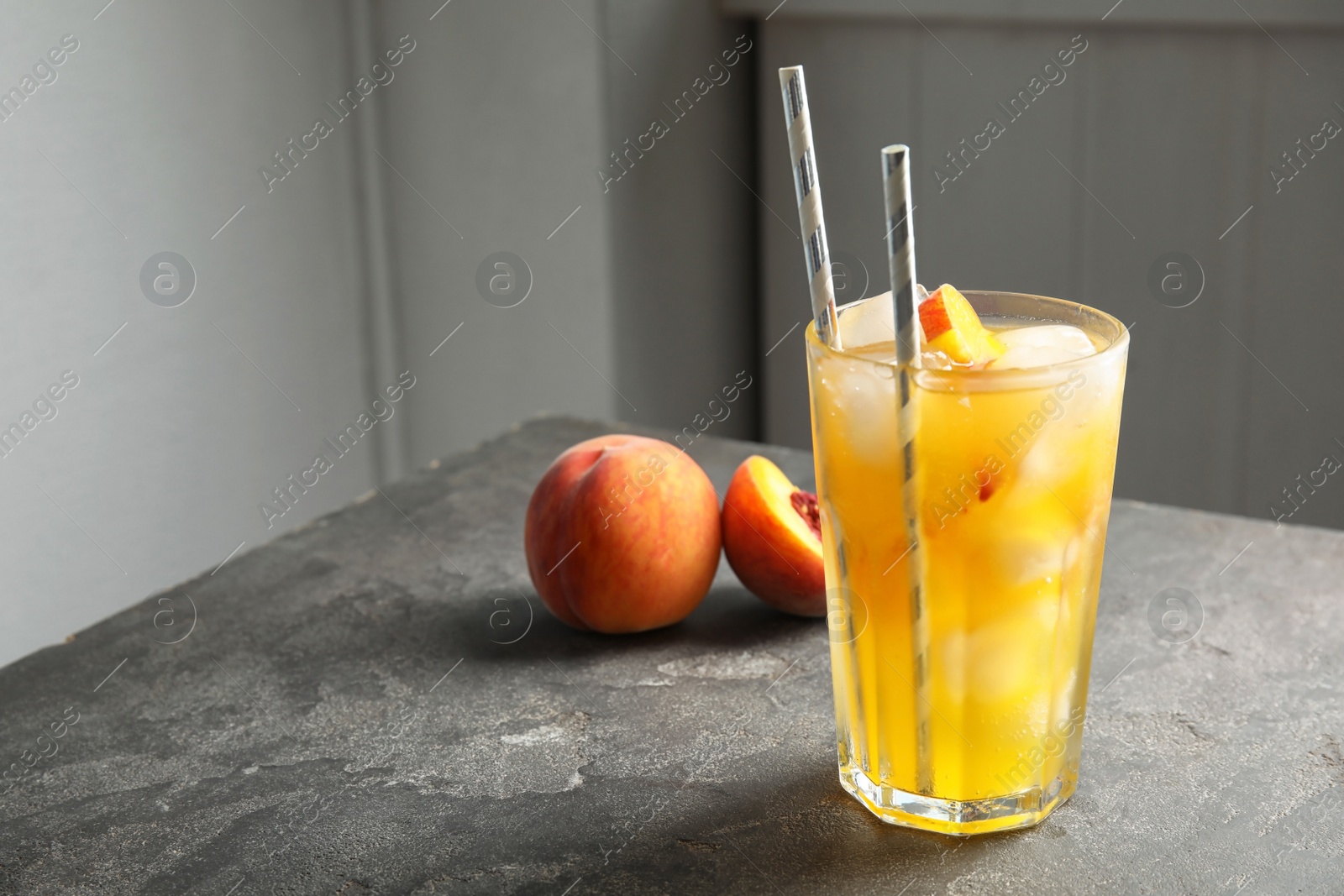 Photo of Tasty peach cocktail on table. Refreshing drink