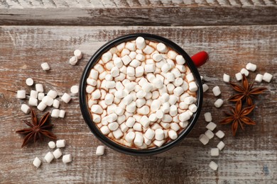 Photo of Tasty hot chocolate with marshmallows on wooden table, top view